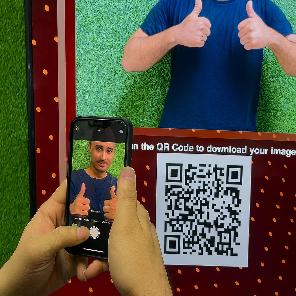 Guest playing interactive event game at exhibition booth in Dubai, pressing button to win prize, with branded screen display and selfie sharing feature for engagement.
